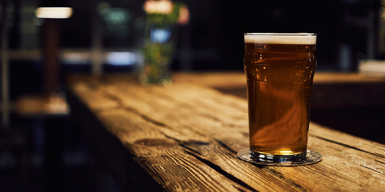 copo de cerveja em balcão de madeira